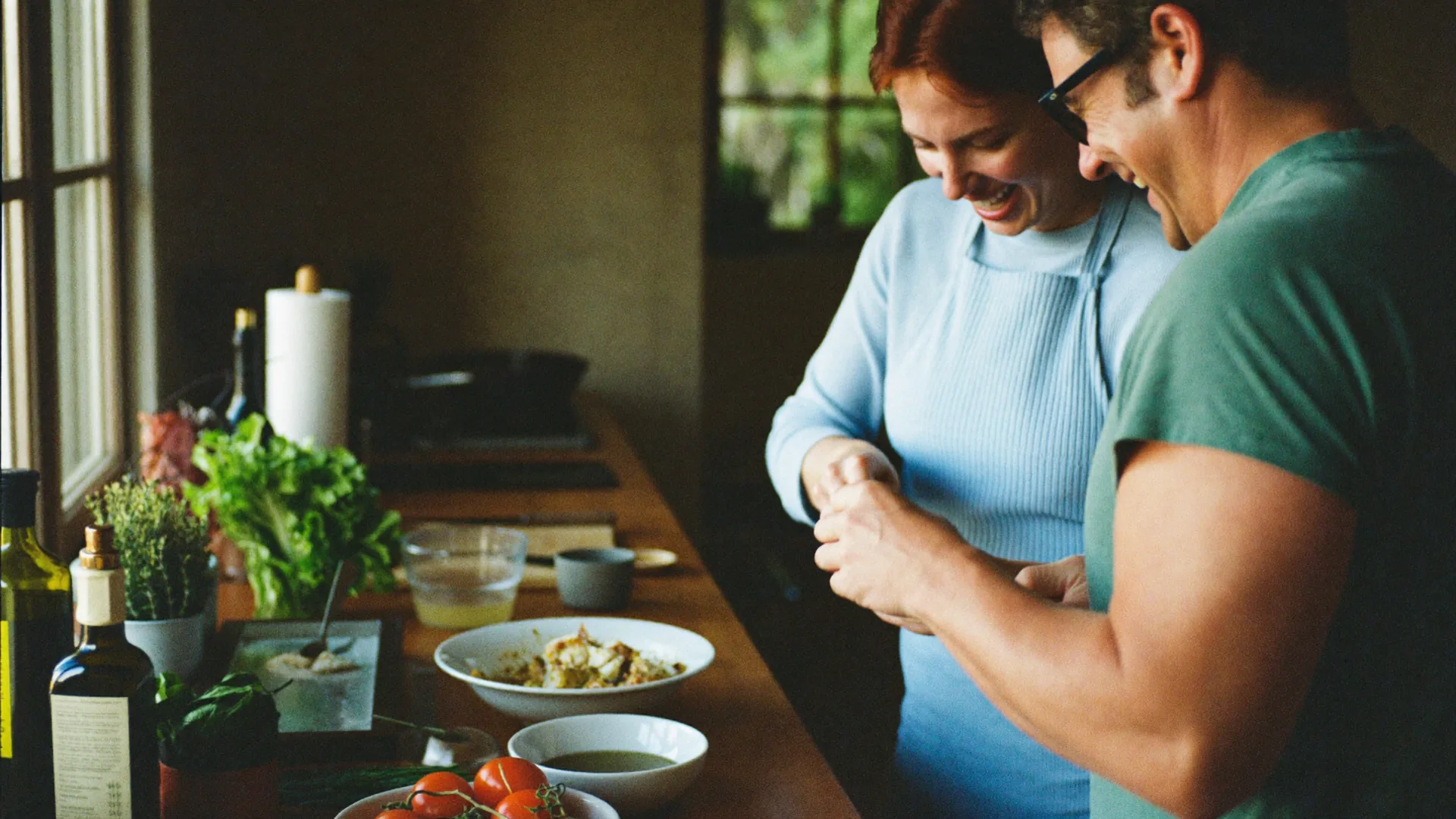 Two friends in their forties cooking a vegetable dinner together in a warm kitchen
